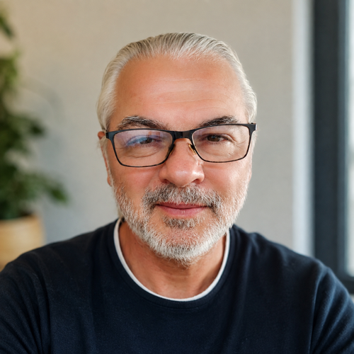 Portrait of Goran Pejić, author of The End of Dieting, smiling warmly in a casual dark shirt with a softly blurred indoor background